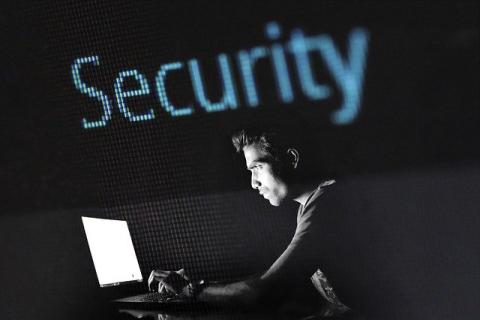 Man sitting at a computer with a blank screen 