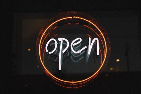 A neon sign saying Open